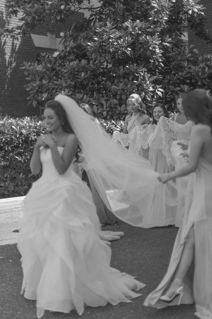 Bride posing with bridesmaids in pale blue dresses — David and Katia wedding