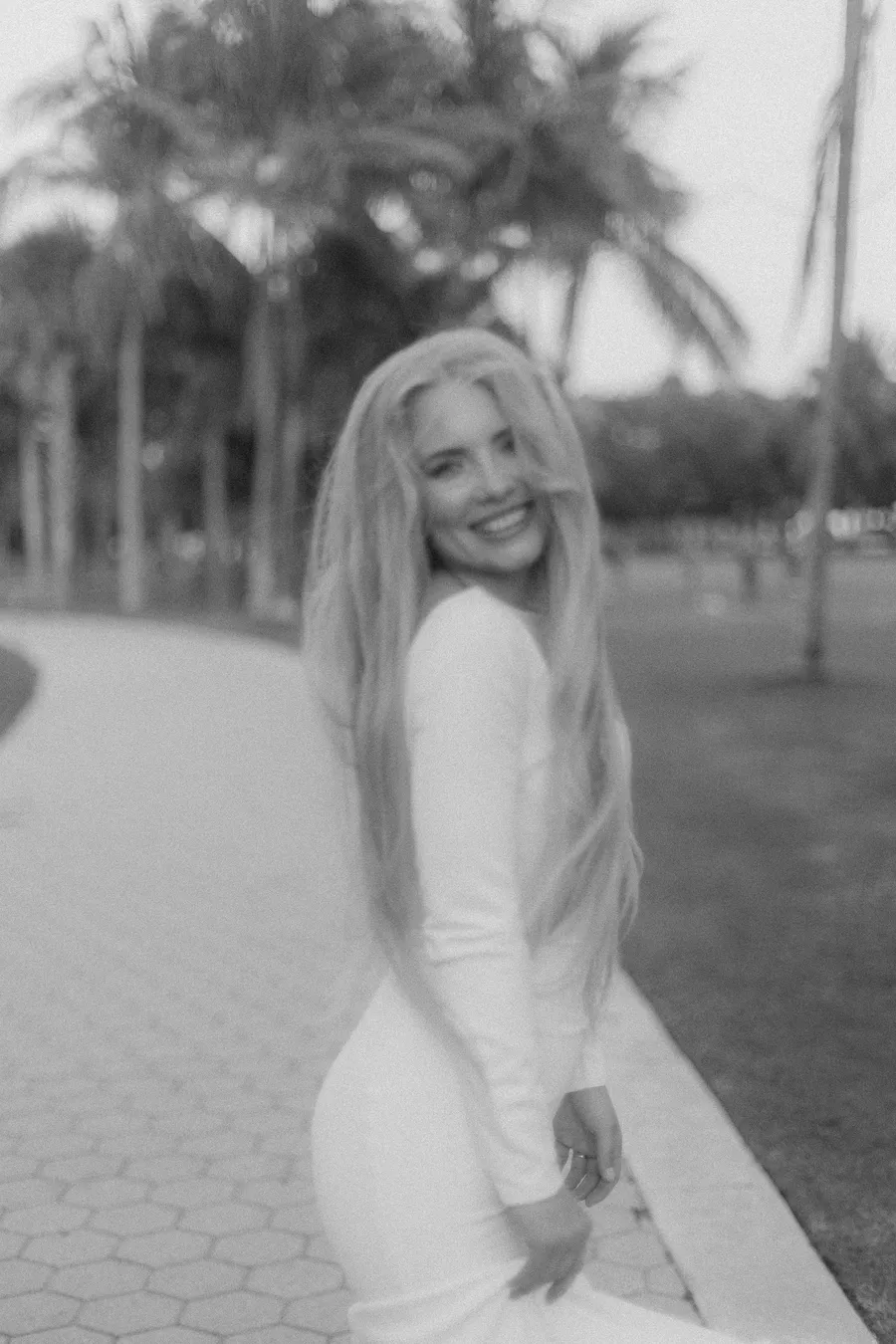 Black-and-white portrait of a smiling bride outdoors