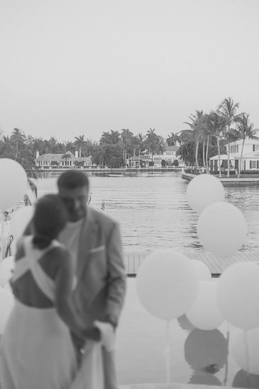 Black-and-white candid of wedding guests beside the waterfront — Alexander and Olga wedding