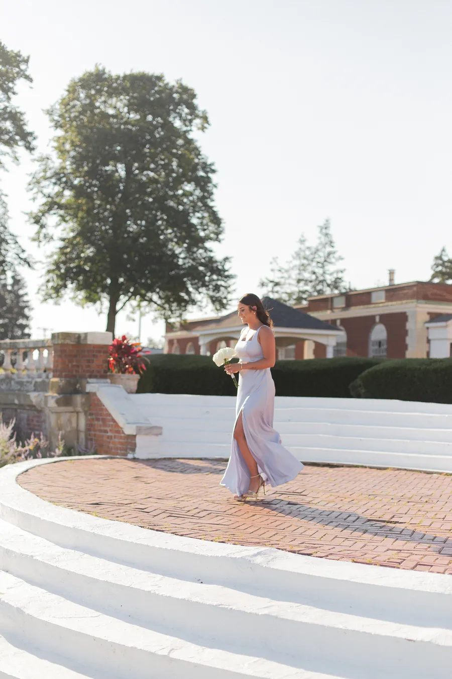 Bride and groom beneath a white floral arch — David and Katia wedding