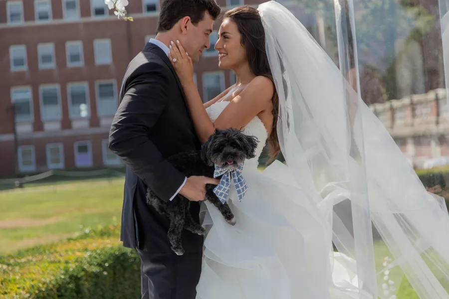 Outdoor ceremony prepared with a white floral arch — David and Katia wedding