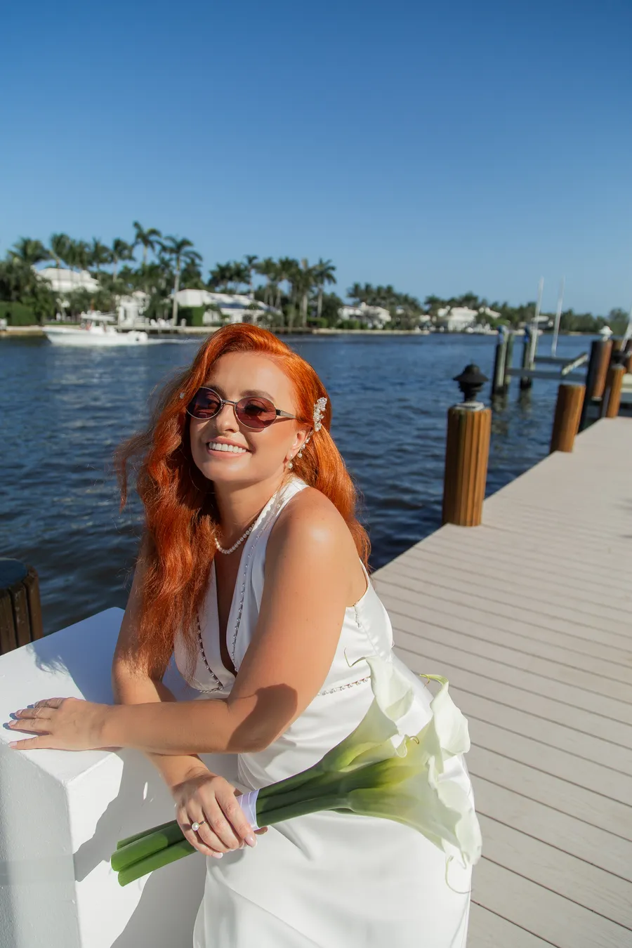 Bride walking along a sunny waterfront dock — Alexander and Olga wedding