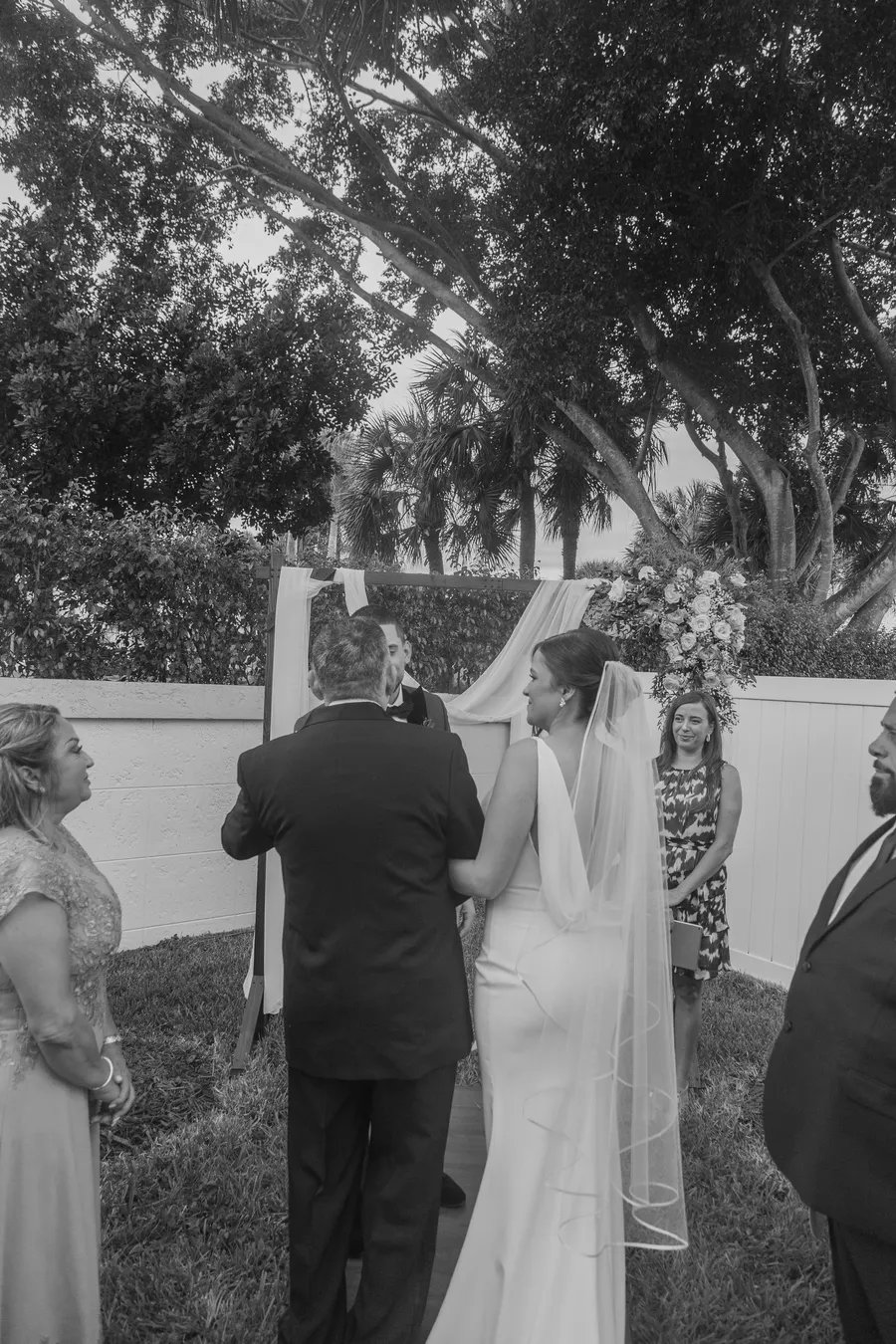 Bride walking toward the garden ceremony — Chris and Laura wedding